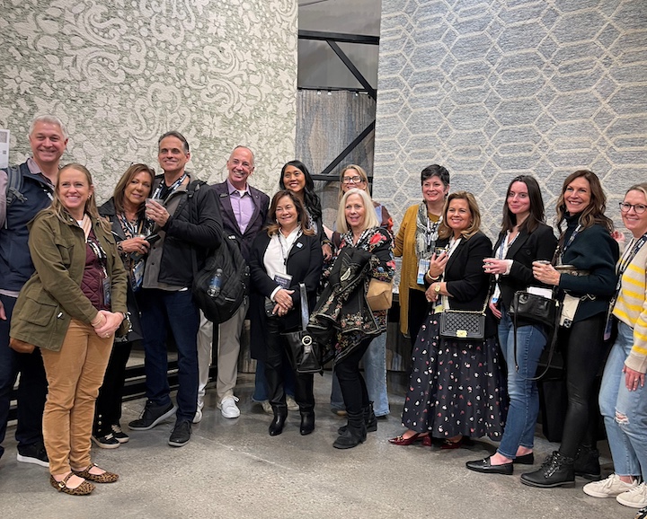 Designers posing in front of Feizy's Belfort collection rugs 8A28F and 8777F